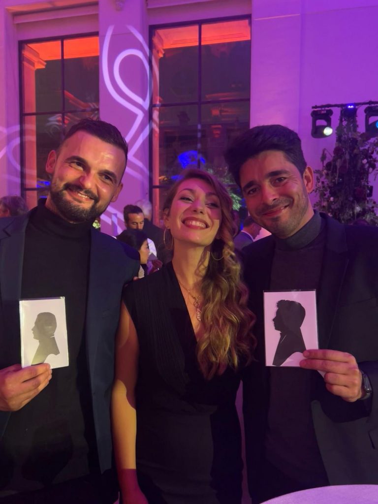 Des invités présentant leurs portraits silhouettes réalisés lors d'une soirée à Genève